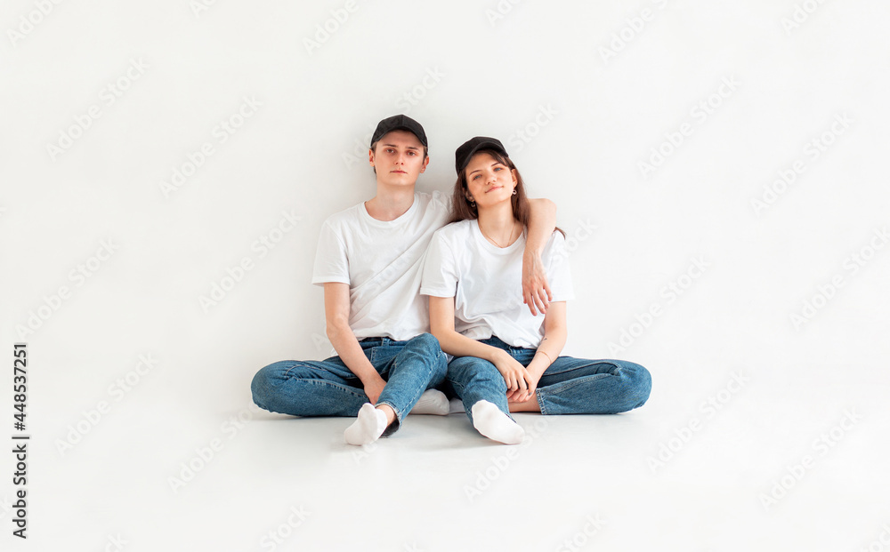 Portrait Of Happy Young Couple Sitting On Floor smiling Portrait Of Happy Young Couple Sitting On Floor smiling