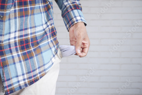 young man shows empty pant pocket with copy space 