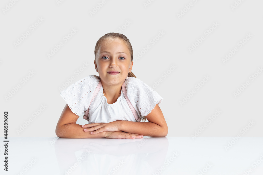 Beautiful Caucasian preschool girl looking at camera isolated over white studio background. Copyspace. Childhood, education, emotions concept Beautiful Caucasian preschool girl looking at camera isolated over white studio background. Copyspace. Childhood, education, emotions concept