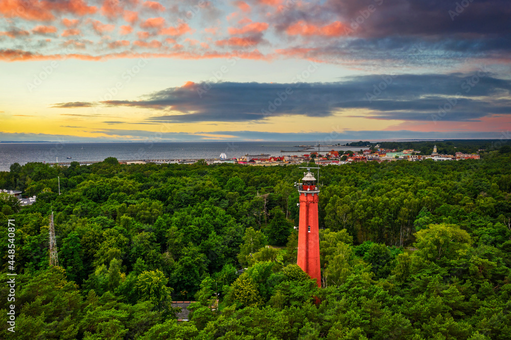 Naklejka premium Red lighthouse on the Hel Peninsula at sunset. Poland.
