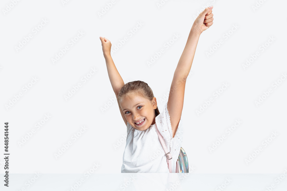 Back to school. Happy Caucasian school girl looking at camera isolated over white studio background. Copyspace. Childhood, education, emotions concept Back to school. Happy Caucasian school girl looking at camera isolated over white studio background. Copyspace. Childhood, education, emotions concept