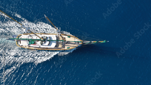 Aerial drone photo of beautiful sailboat cruising deep blue open ocean Aegean sea © aerial-drone