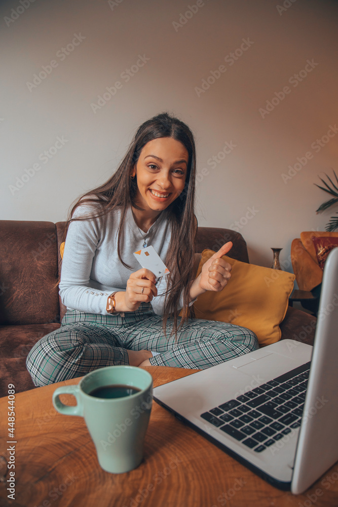 Fototapeta premium Woman holding credit card and shopping online.
