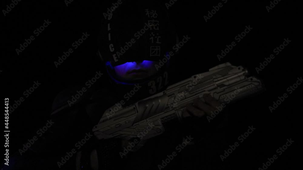 Cyberpunk concept, future world. Police officer cop in dark, halfman bionic cyborg or android reloads gun, twitches cocking lever, Stands looks at camera in dark. Science fiction scene, fantasy, sci Cyberpunk concept, future world. Police officer cop in dark, halfman bionic cyborg or android reloads gun, twitches cocking lever, Stands looks at camera in dark. Science fiction scene, fantasy, sci