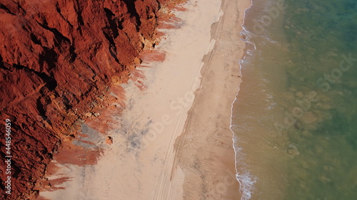 Contrasting red cliffs and blue seas photo