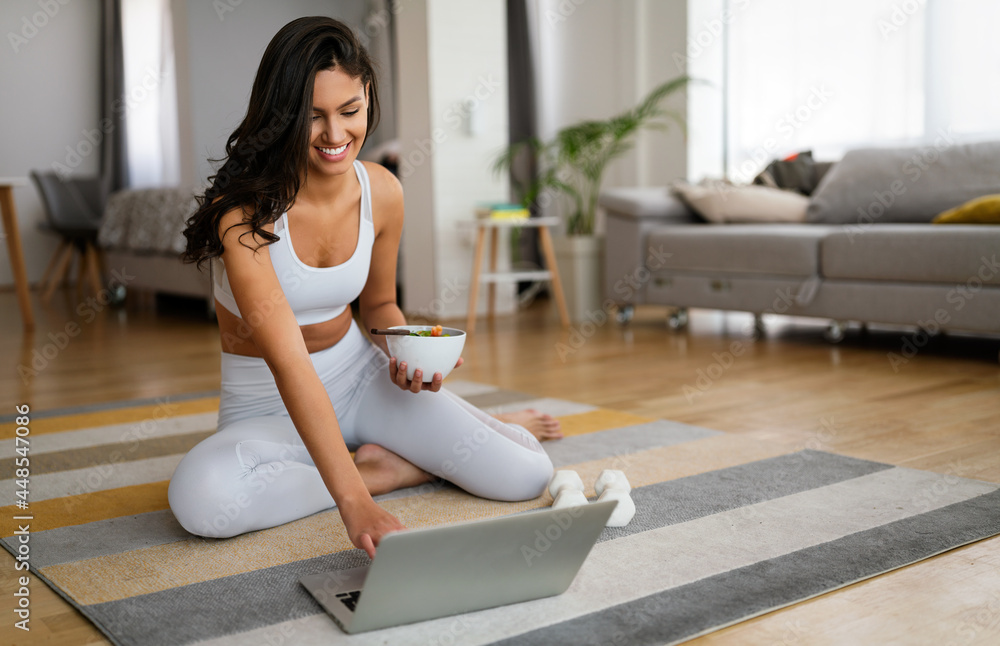 Young woman eating a healthy salad after workout. Fitness and healthy lifestyle concept. Young woman eating a healthy salad after workout. Fitness and healthy lifestyle concept.