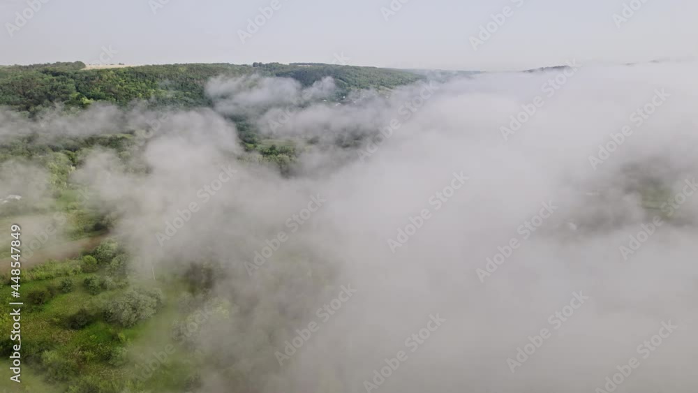 Aerial drone view on forest covered with haze. Flying through low clouds. Calmness background, relaxation, beauty of earth, nature concept Aerial drone view on forest covered with haze. Flying through low clouds. Calmness background, relaxation, beauty of earth, nature concept