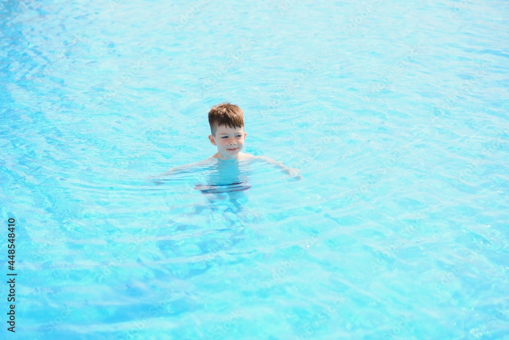 Kid splashing on summer pool