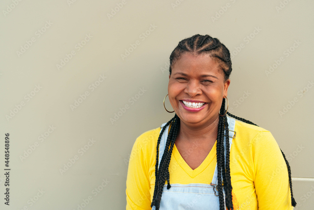 African woman outside the city, looking at the camera smiling. African woman outside the city, looking at the camera smiling.