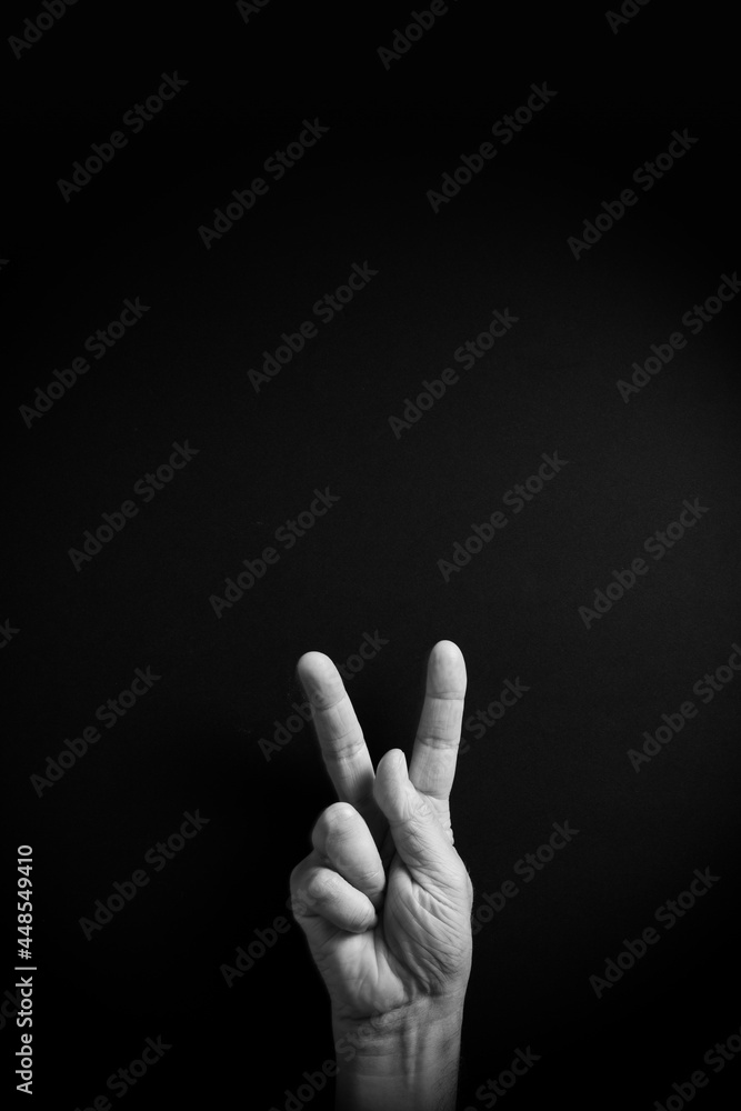 B&W image of hand demonstrating ASL sign language letter K with empty copy space B&W image of hand demonstrating ASL sign language letter K with empty copy space
