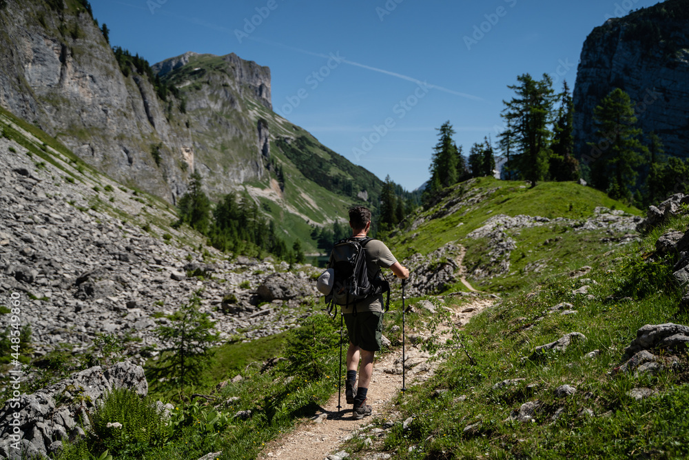 Fototapeta premium Junger Mann wandert bei schönem Wetter in den Bergen in Österreich Steiermark