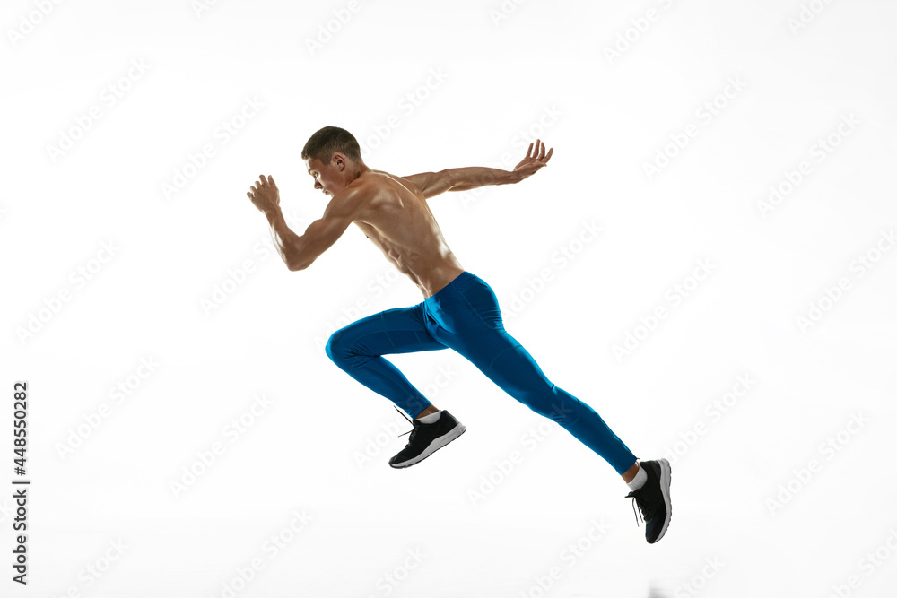 One Caucasian professional male athlete, runner training isolated on white studio background. Muscular, sportive man. Concept of sport, healthy lifestyle