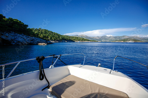 side front of a motor yacht going to the sea towards the mountains. Luxurious travel life. Beautiful view from the boat to the Croatian islands