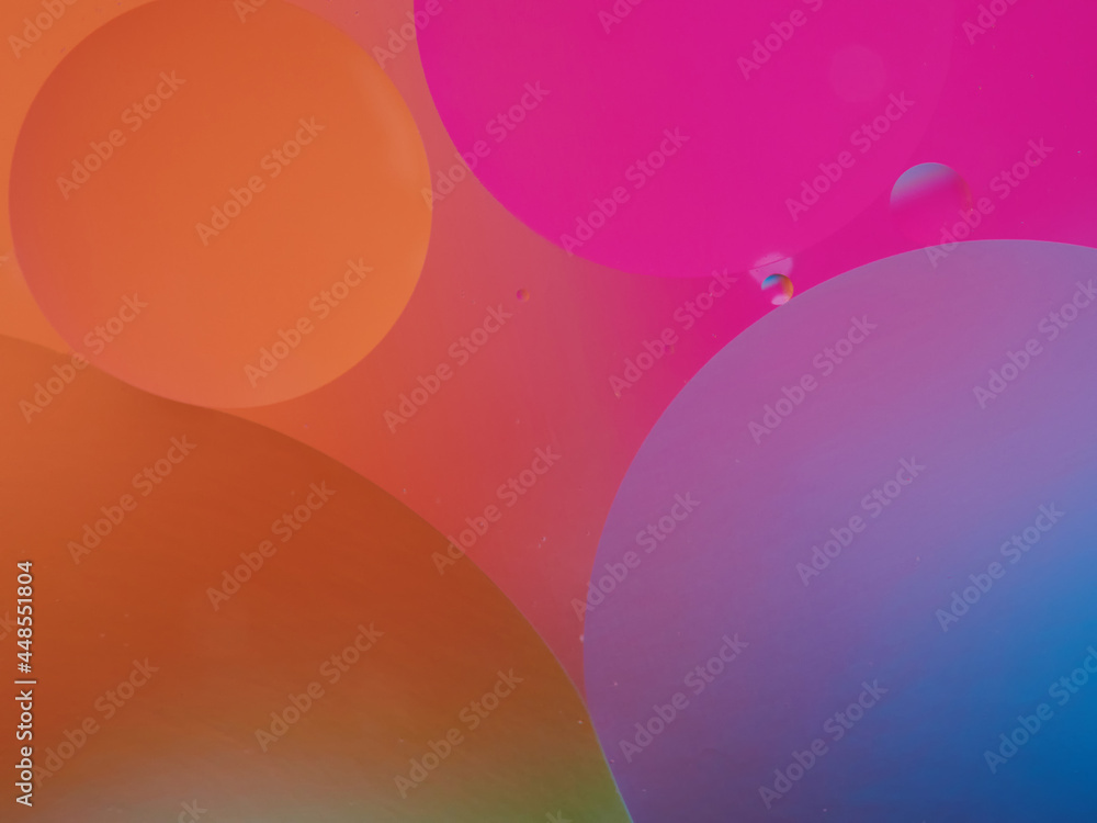 Closeup of oil drops motion on water surface. Colorful abstract macro background of oil drops on water surface with air bubbles inside Closeup of oil drops motion on water surface. Colorful abstract macro background of oil drops on water surface with air bubbles inside