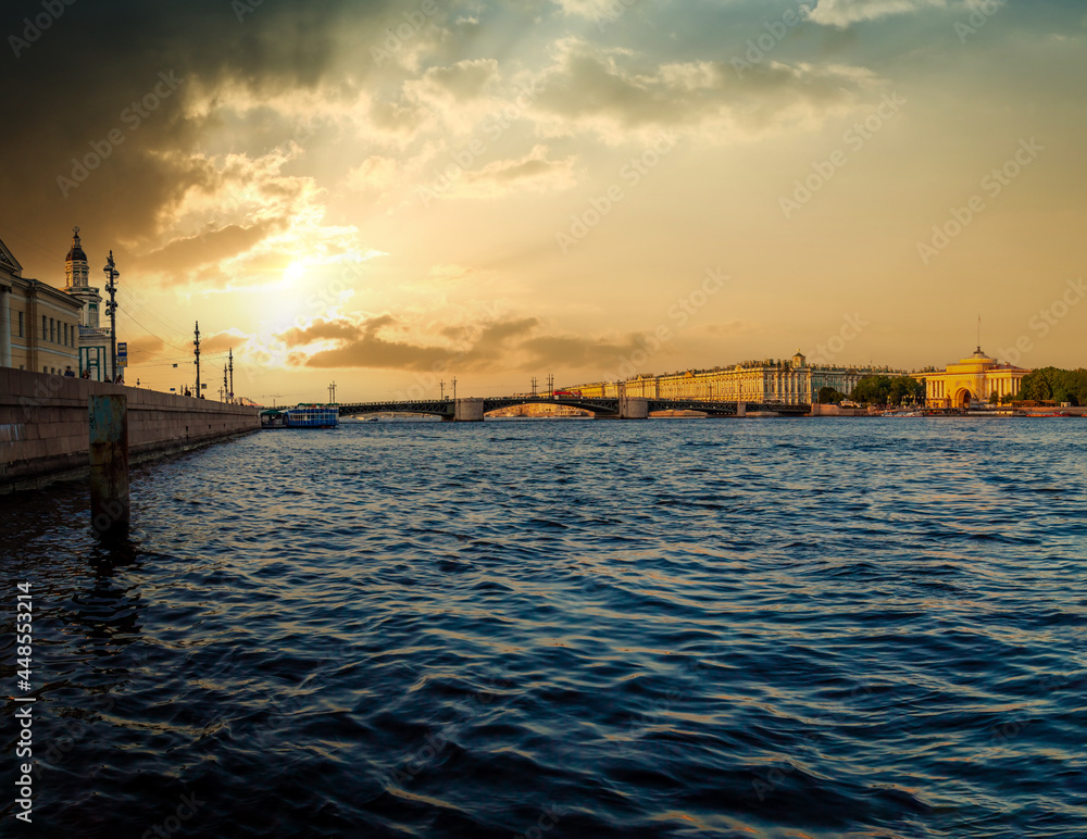 Sunset over the city, St. Petersburg. Russia. Water view of the Admiralty building and the Palace Bridge.