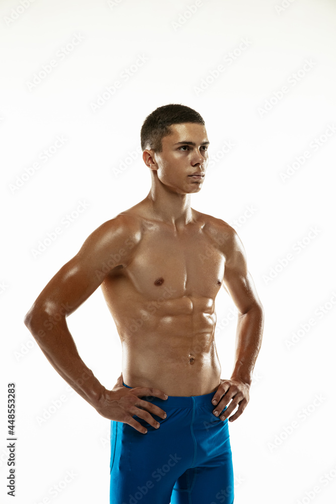 Portrait of young muscular man, male athlete, runner isolated on white studio background. Concept of sport, healthy lifestyle. Power and beauty Portrait of young muscular man, male athlete, runner isolated on white studio background. Concept of sport, healthy lifestyle. Power and beauty