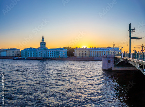 Bridge over the river at sunset in the historical place of St. Petersburg. Russia. View of the spit of Vasilievsky Island and the Palace Bridge.