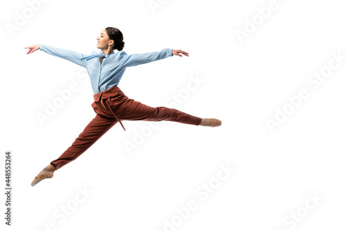 Side view of cheerful ballerina jumping isolated on white