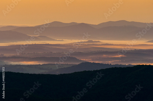 Morning mists illuminated by the rays of the rising sun seen from the summit of Połonina Wetlińska, the Bieszczady Mountains, the Carpathians
