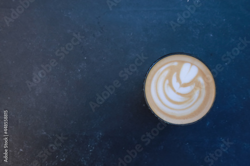 Cup of latte with foamy art. Cappuccino mug milk and coffee glass on dark black, grey concrete table background. For coffee shop templates, cafe, morning concept
