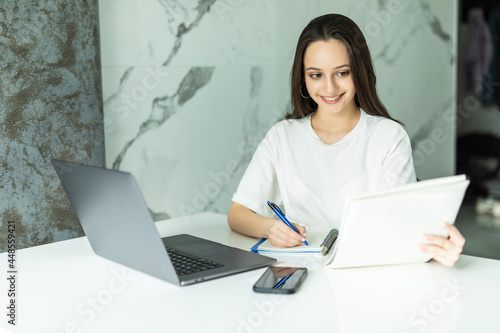 Thoughtful young woman thinking using business vision near calculator and laptop for calculating finance rates looking at future.