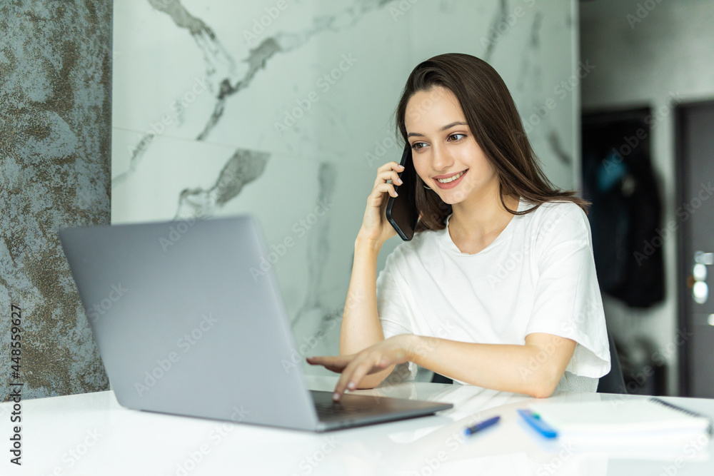 Worried young dressed casually sitting at kitchen table, holding paper sheet and talking to house and utilities service representative about miscalculation in bills Worried young dressed casually sitting at kitchen table, holding paper sheet and talking to house and utilities service representative about miscalculation in bills