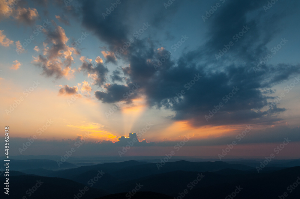 Morning clouds illuminated by the rays of the rising sun seen from the summit of Połonina Wetlińska, the Bieszczady Mountains, the Carpathians