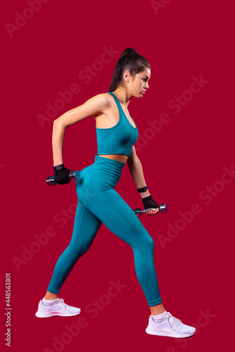 Profile photo of sportswoman with dumbbell fit slim abs body practicing fitness exercises with position legs spread wide. 