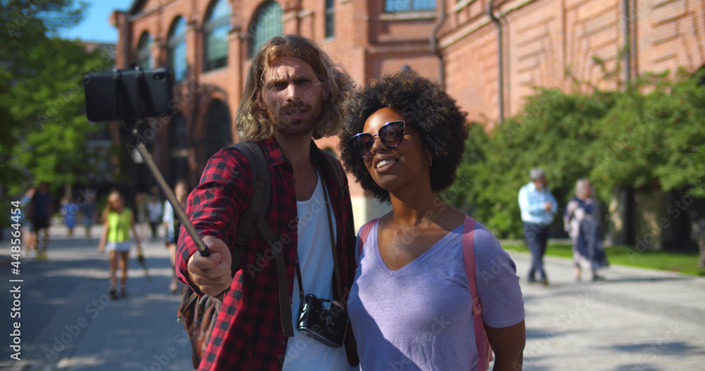 Multiethnic blogger couple travel using mobile phone make online vlog