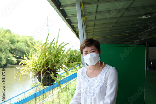 Asian women wear masks to prevent contagious diseases during epidemics while traveling in ancient places.
