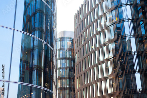 Skyscrapers business centers with glass walls in the rays of the setting evening summer sun