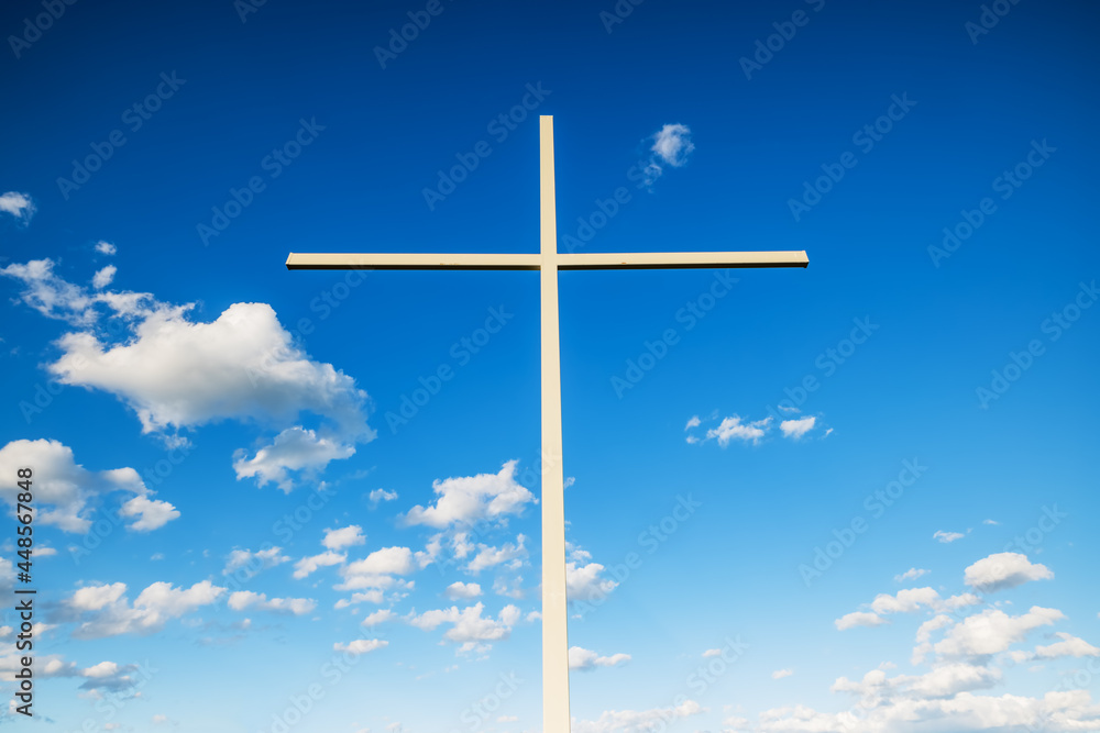 Christian cross against sky and clouds