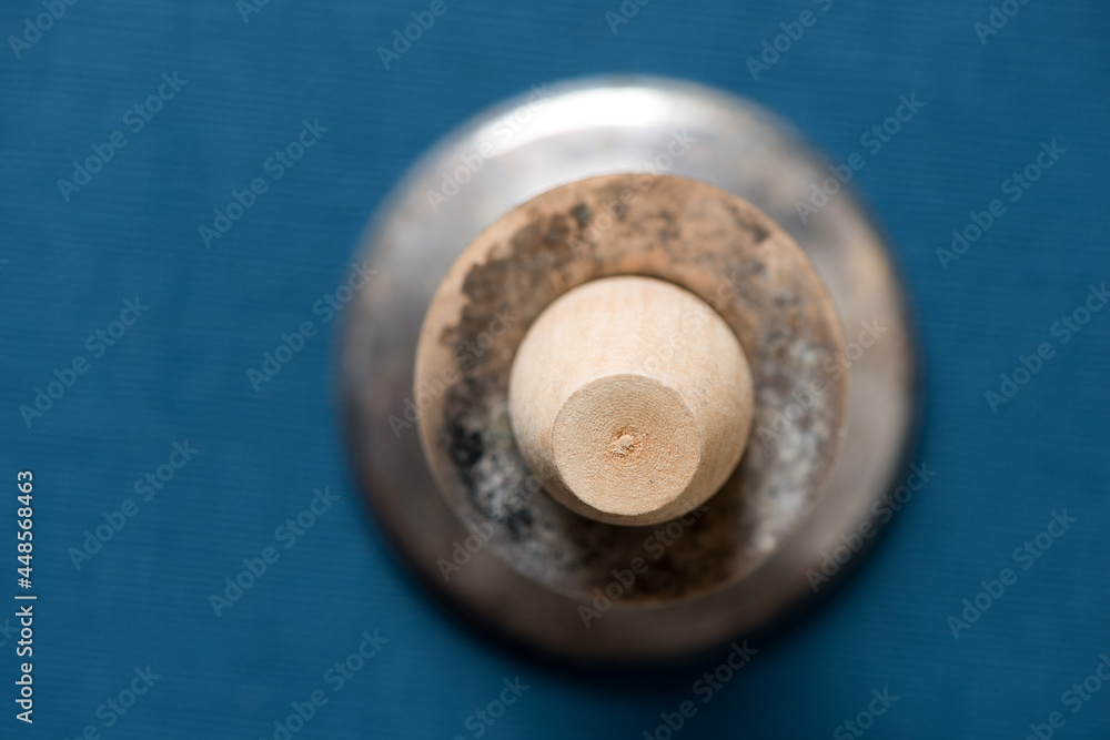 isolated wooden object in a candle stick holder on a dark blue background isolated wooden object in a candle stick holder on a dark blue background