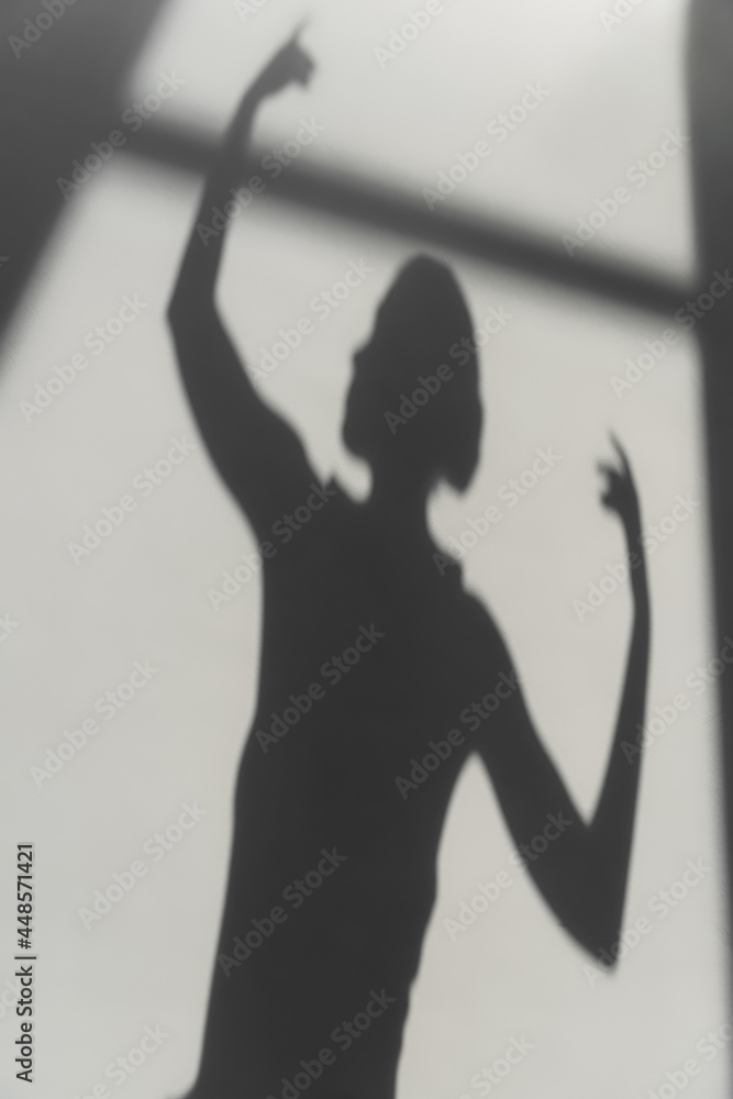 Fototapeta premium Shadow of elegant ballerina on grey background