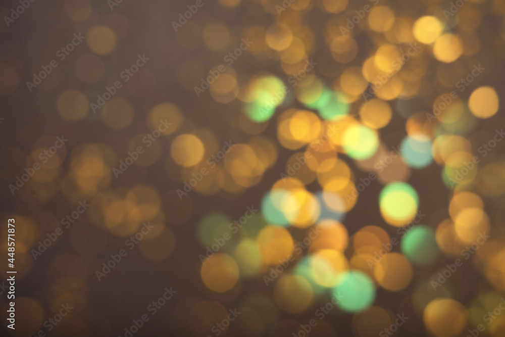 Blurred view of shiny lights on grey background. Bokeh effect Blurred view of shiny lights on grey background. Bokeh effect