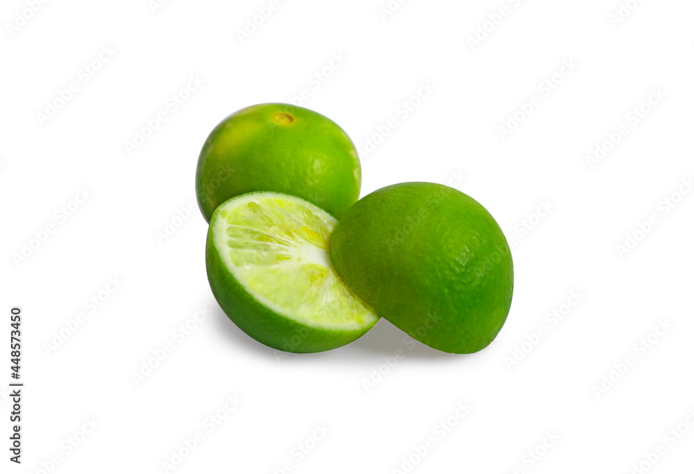 One fresh green full and halved lemon on a white background. One fresh green full and halved lemon on a white background.