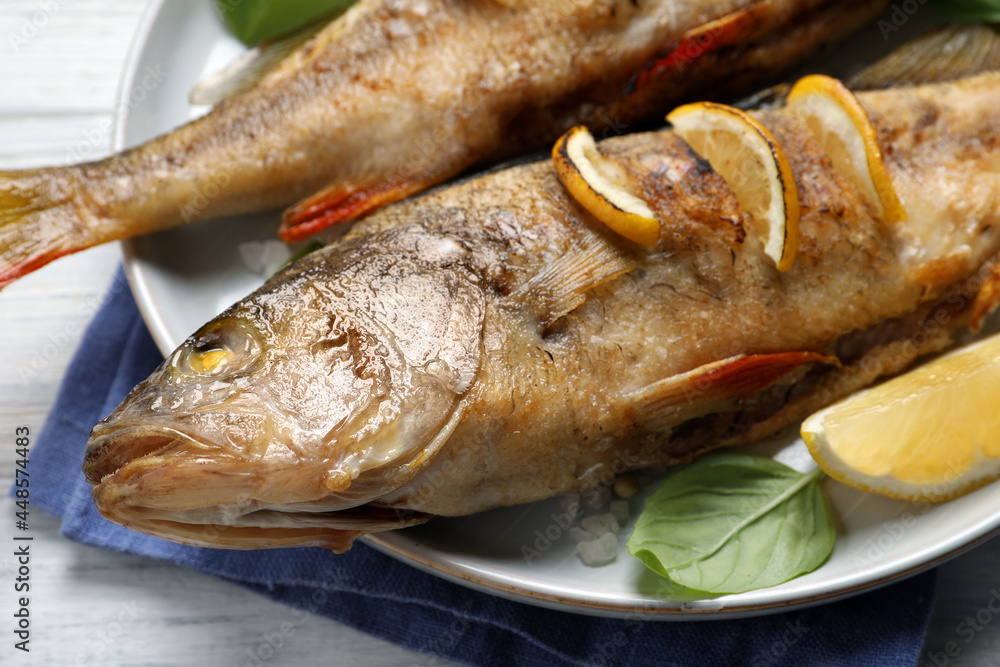 Tasty homemade roasted perches on white table, closeup. River fish Tasty homemade roasted perches on white table, closeup. River fish