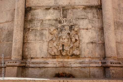 Detail of some stone carved lion heads on a fountain in Dubrovnik, Croatia
