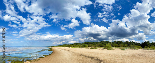 Panorama of the warm Gulf of Riga of the Baltic Sea against the background of cumulus clouds. The coast of the Gulf of Riga in Latvia is popular with tourists. photo