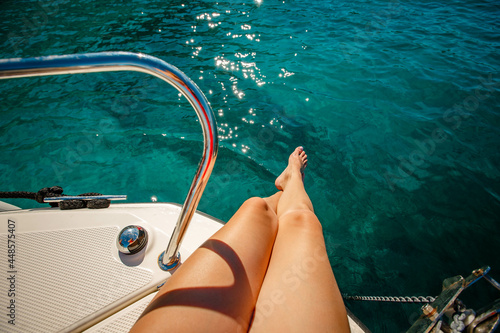 Closeup on beautiful sexy women's feet on the yacht, carefree vacation, journey on sailboat, happy and healthy lifestyle, pleasure concept
