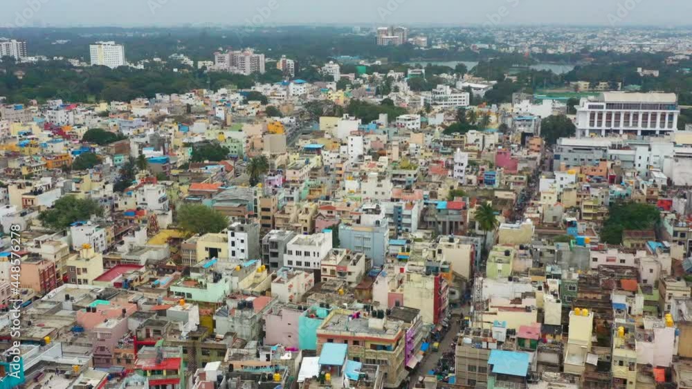 Flying over urban community toward lake in Bangalore India