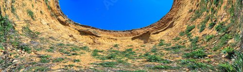 Abstract circle view of mysterious historic gravel pit in a natural habitat of sand martin flight of flock swallows Riparia riparia. Rhineland Palatinate, Eckelsheim, Germany photo