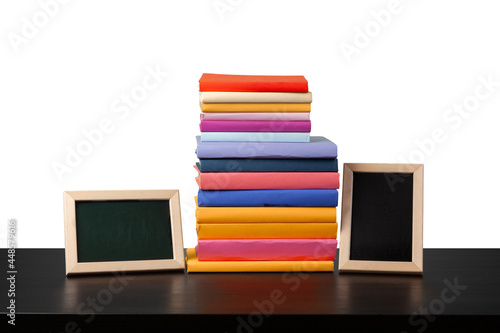 Stack of books on wooden table against white background