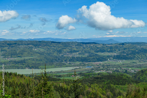 A panoramic view on Ferlacher Stausee, Austrian Alps. The river Drava is running through the valley. In the back the mountain chain Koralpe can be seen. Wanderlust
