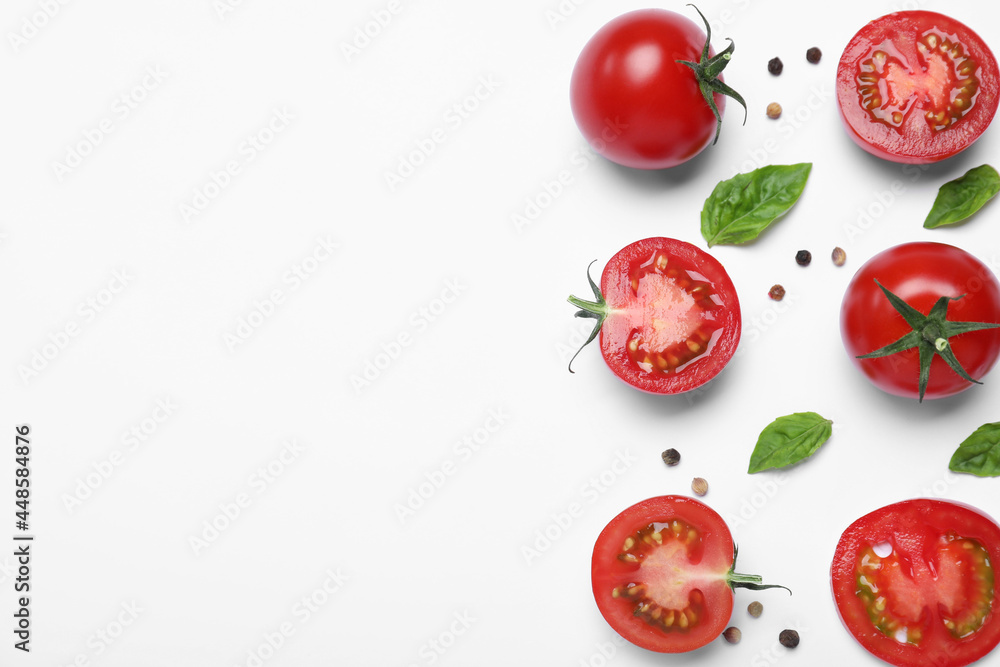 Fototapeta premium Fresh basil leaves and tomatoes on white background, flat lay. Space for text