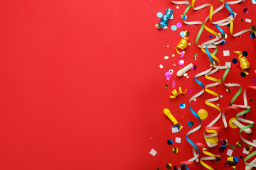 Flat lay composition with carnival items on red background. Space for text