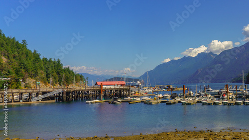 Spectacular ocean, mountain and forest scenery viewed from Horseshoe Bay marina, BC, mid-summer with departing ferry visible in background