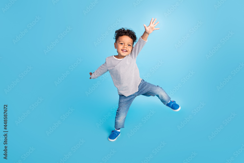 Full length body size view of attractive cheerful carefree boy dancing good mood isolated over bright blue color background