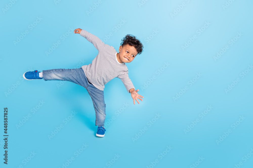 Full length body size view of attractive cheerful sporty boy dancing break having fun isolated over bright blue color background Full length body size view of attractive cheerful sporty boy dancing break having fun isolated over bright blue color background