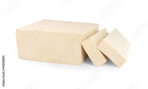 Cut raw tofu block on white background